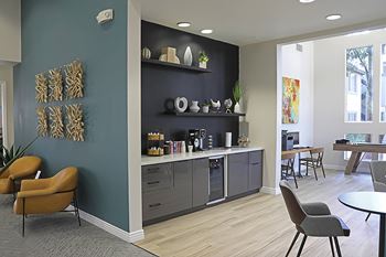 A modern office space with a blue wall and a brown chair.